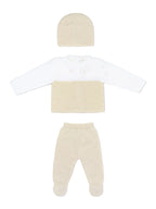 A three-piece baby knit outfit set featuring a long-sleeve top with a white and beige color-blocked design, matching beige footed pants, and a beige knit beanie, laid out on a light gray background.