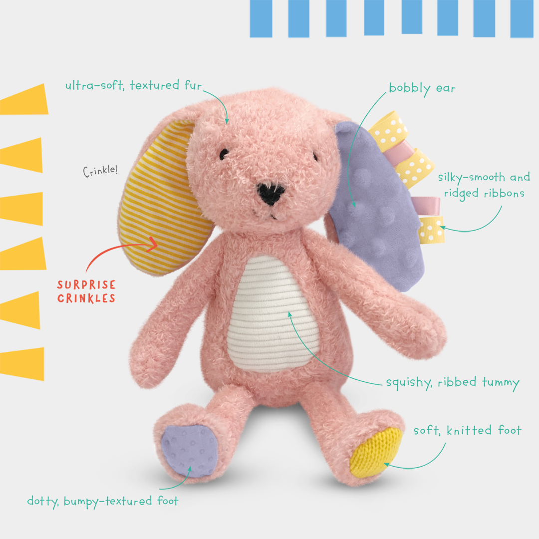 Pink plush toy with features highlighted on a white background