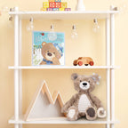 Children's room with a white shelf displaying toys and a book against a yellow wall.