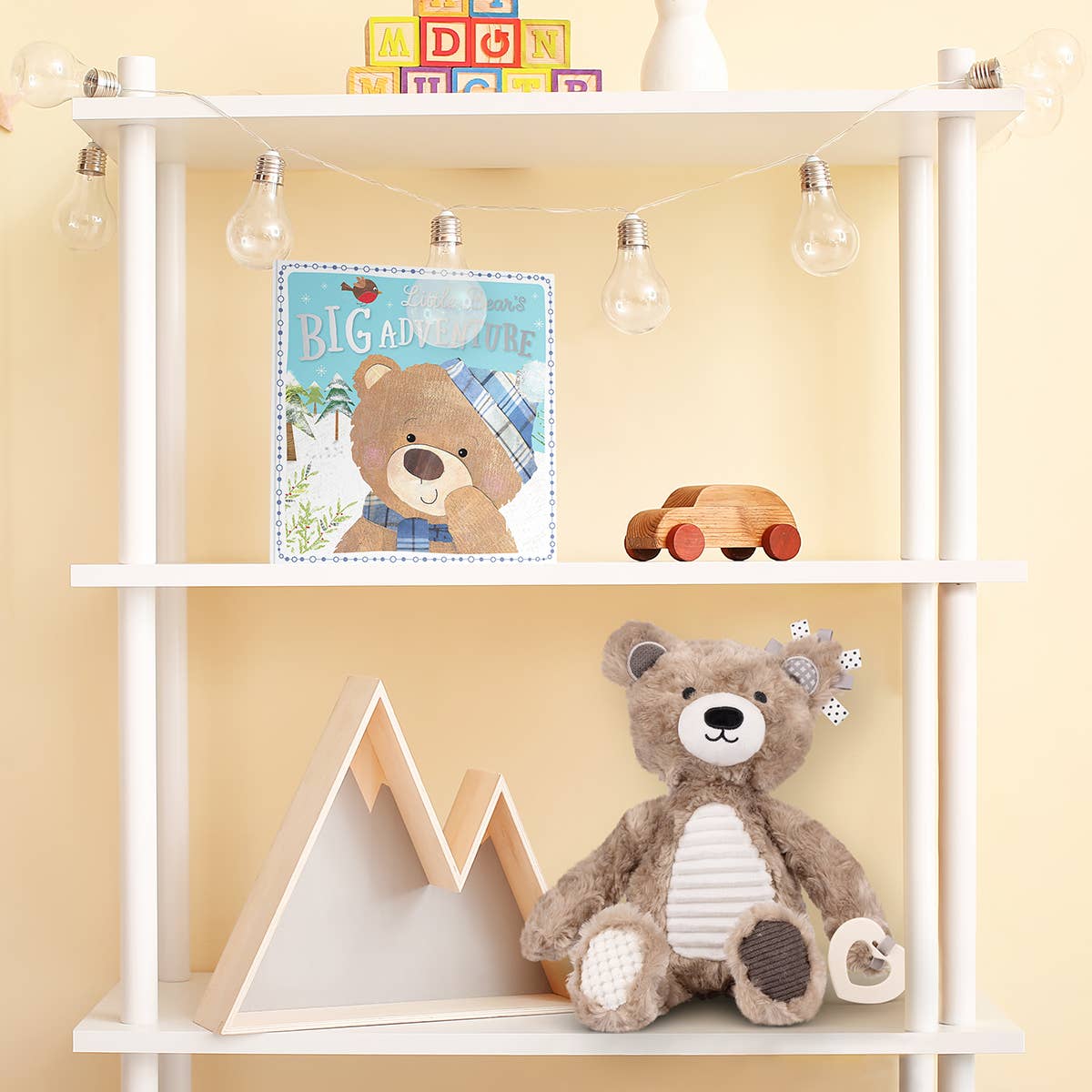 Children's room with a white shelf displaying toys and a book against a yellow wall.