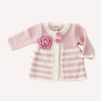 Pink and white striped baby sweater with a flower design on a white background