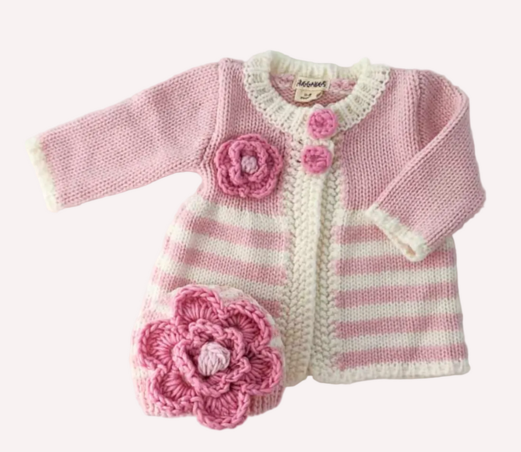 Pink and white striped baby outfit with floral details on a light gray background