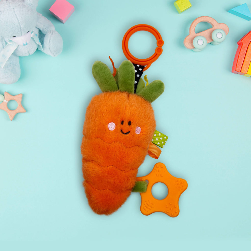 Carrot-shaped teething toy with a smiley face on a light blue background - AdoraBaby.co.uk