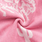 Close-up of pink fabric with cowboy boot patterns on a baby romper AdoraBaby.co.uk