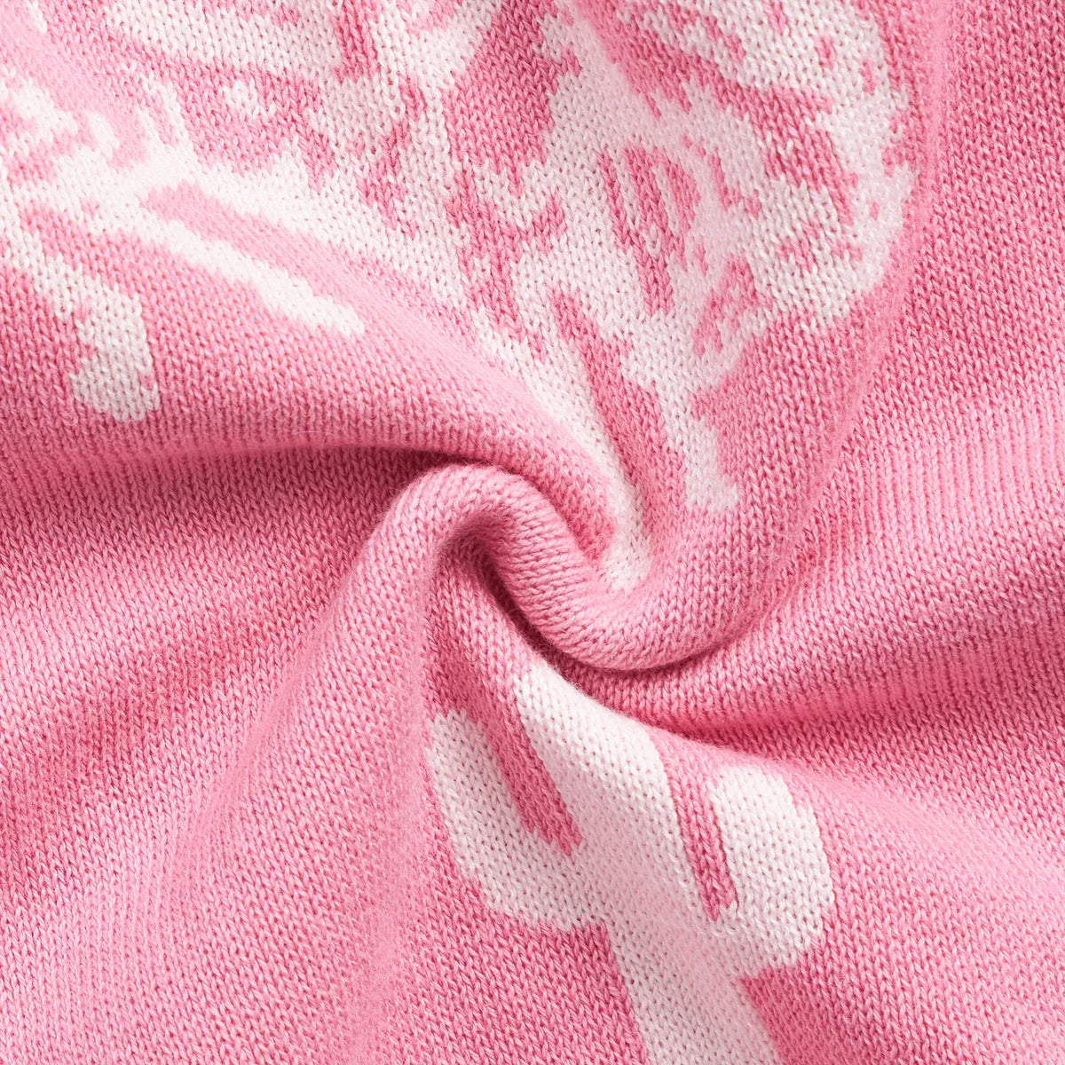 Close-up of pink fabric with cowboy boot patterns on a baby romper AdoraBaby.co.uk