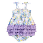 Baby romper with floral top and ruffled bottom on a white background