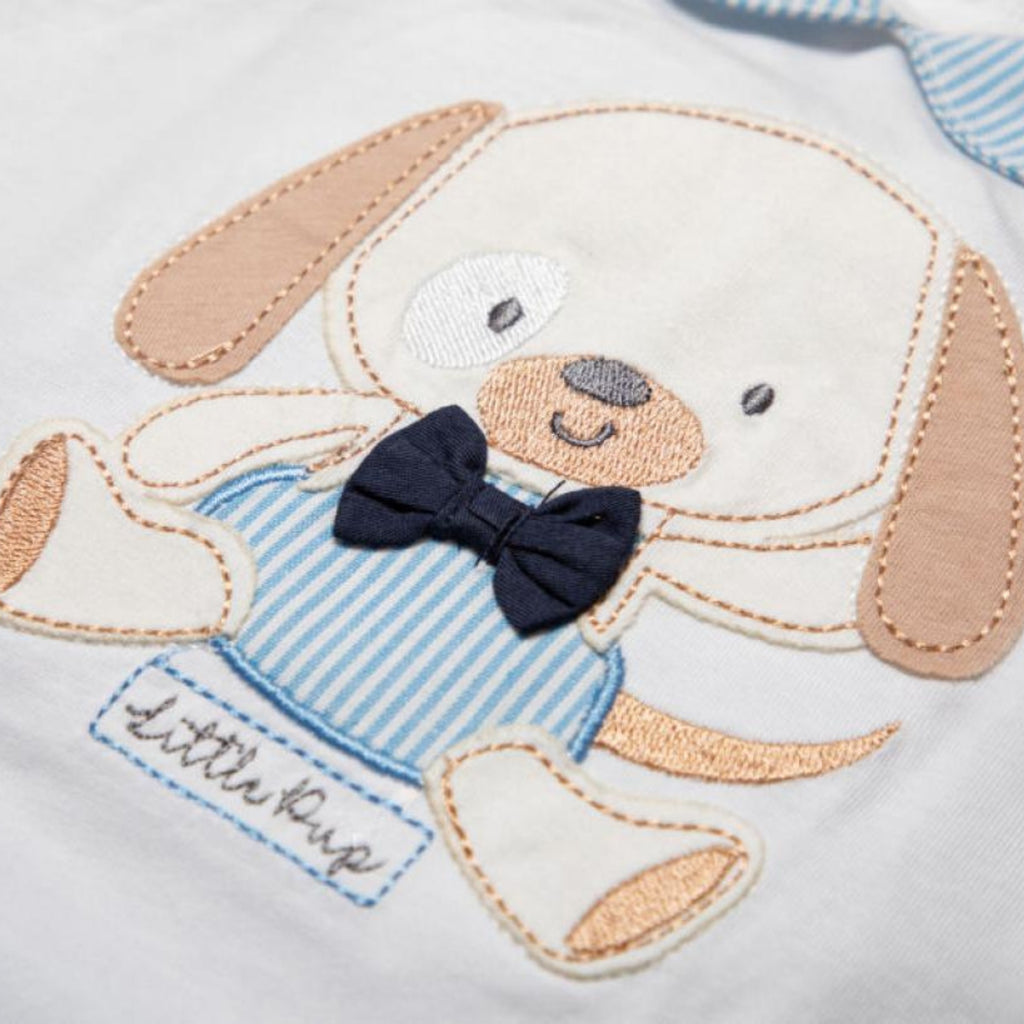 Embroidered dog design on a baby outfit with 'little pup' text.