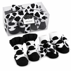 Cow print baby socks with a clear packaging box on a white |background | AdoraBaby.co.uk