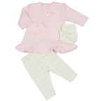 A baby girl's two-piece outfit set featuring a light pink long-sleeve top with a ruffled hem and bow details, paired with cream leggings patterned with small pink bows. A matching cream bow is shown alongside the product on a white background.