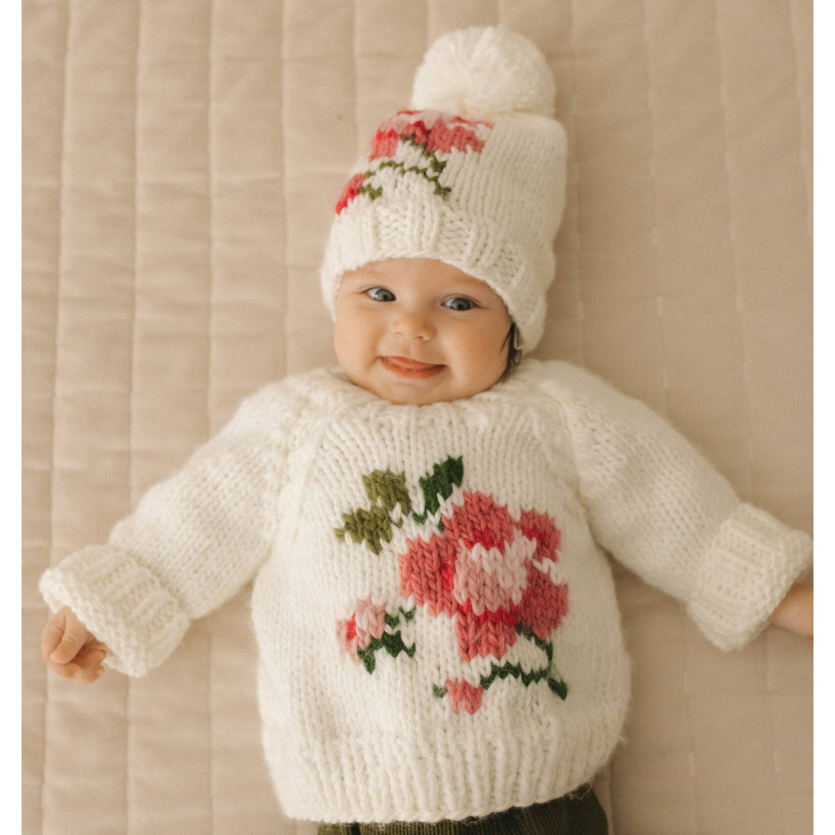 white knitted baby sweater with floral patterns and a matching hat AdoraBaby.co.uk