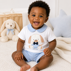 Baby boy wearing Rockabye baby puppy shorts set with blue striped shorts and puppy appliqué top