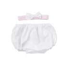 White baby bloomers with a pink headband on a beige background