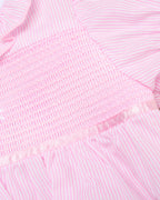 Close-up of a pink textured fabric with a subtle pattern