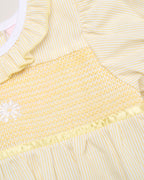 Close-up of a yellow ruffle smocked daisy romper - Adorababy.co.uk