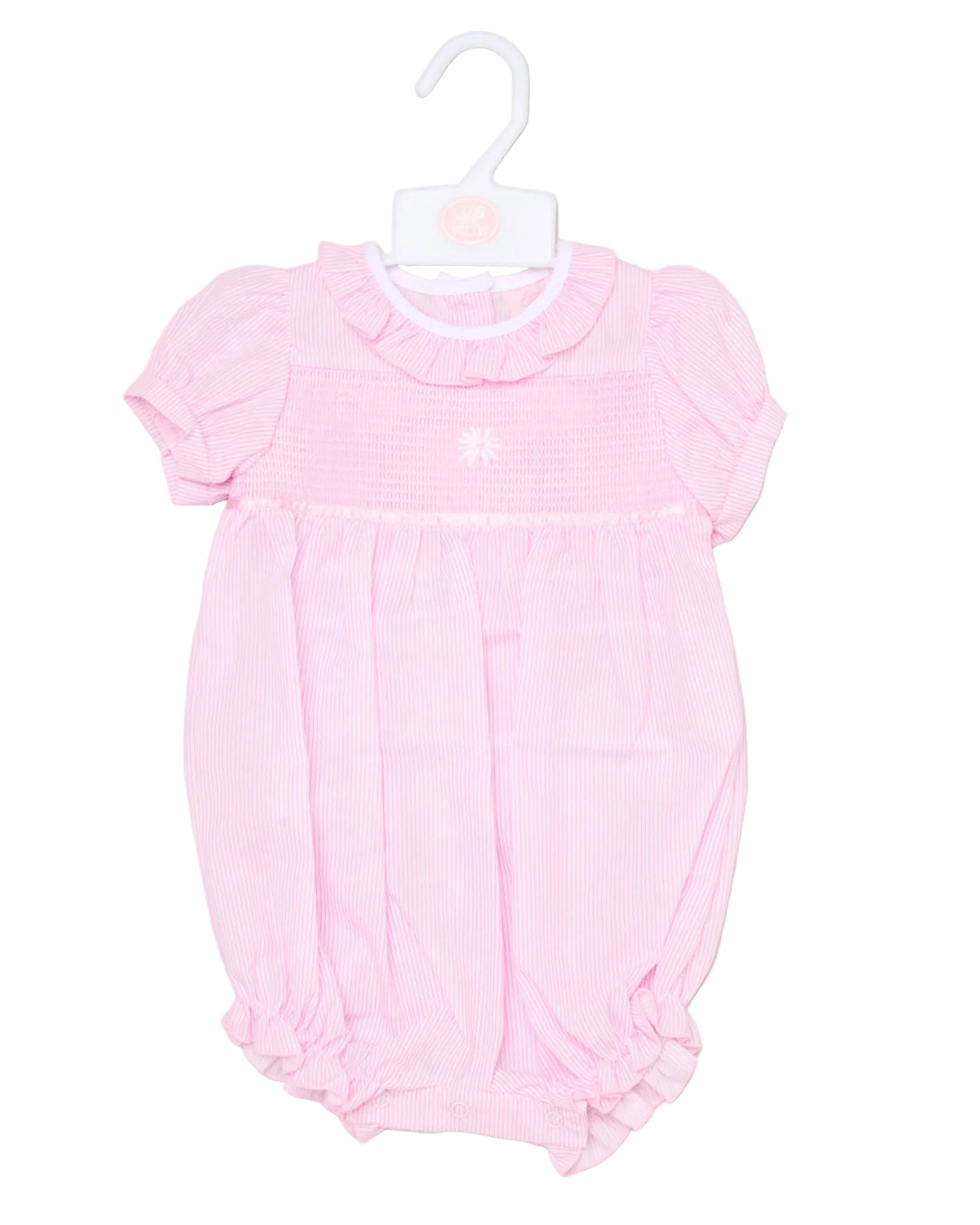 Pink baby romper on a hanger against a beige background