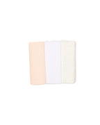 Three folded towels in beige, white, and pink on a light beige background