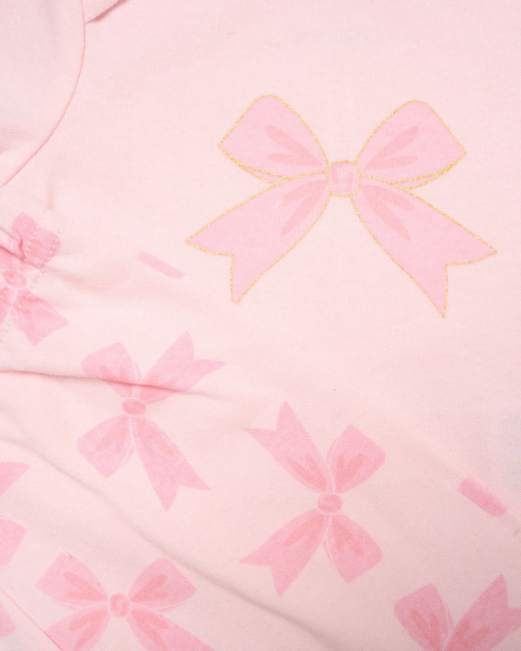 Close-up of pink fabric with bow pattern