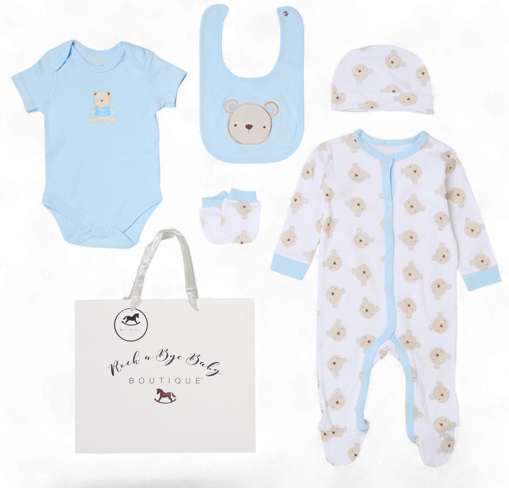 Baby clothing set with onesie, bib, hat, and diaper bag from Rock a Bye Baby Boutique on a white background. Baby Bear 5 Piece Newborn Gift Set in Sky Blue | Baby Boy Gift Set | Adorababy.co.uk