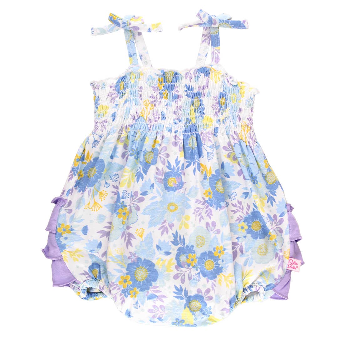 Floral baby romper with ruffles on a white background