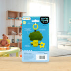 Squish & Snuggle toy packaging with a broccoli-shaped teether on a wooden surface. AdoraBaby.co.uk