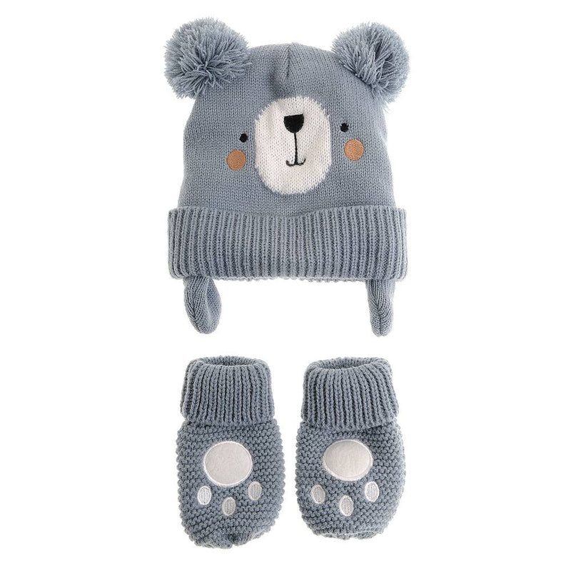 A baby winter hat and bootie set in dusty blue-gray. The knit hat features a bear face with a white snout, black nose, orange cheeks, and fluffy pom-poms on top.