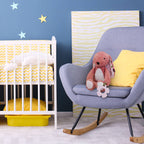 Nursery room with a crib, rocking chair, and decorative elements.