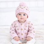 Baby wearing a Huggalugs hand Knitted baby cardigan and hat with pink floral pattern - Aodrababy.co.uk