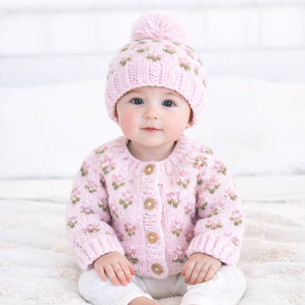 Baby wearing a Huggalugs hand Knitted baby cardigan and hat with pink floral pattern - Aodrababy.co.uk