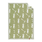 A rectangular golf-themed baby blanket with a sage green background and a white repeating pattern of golf bags, clubs, flags, and tees, shown on a plain white background with one corner folded over.