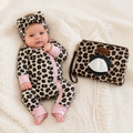 Baby in leopard print outfit with matching pouch on a soft surface | Adorababy.co.uk
