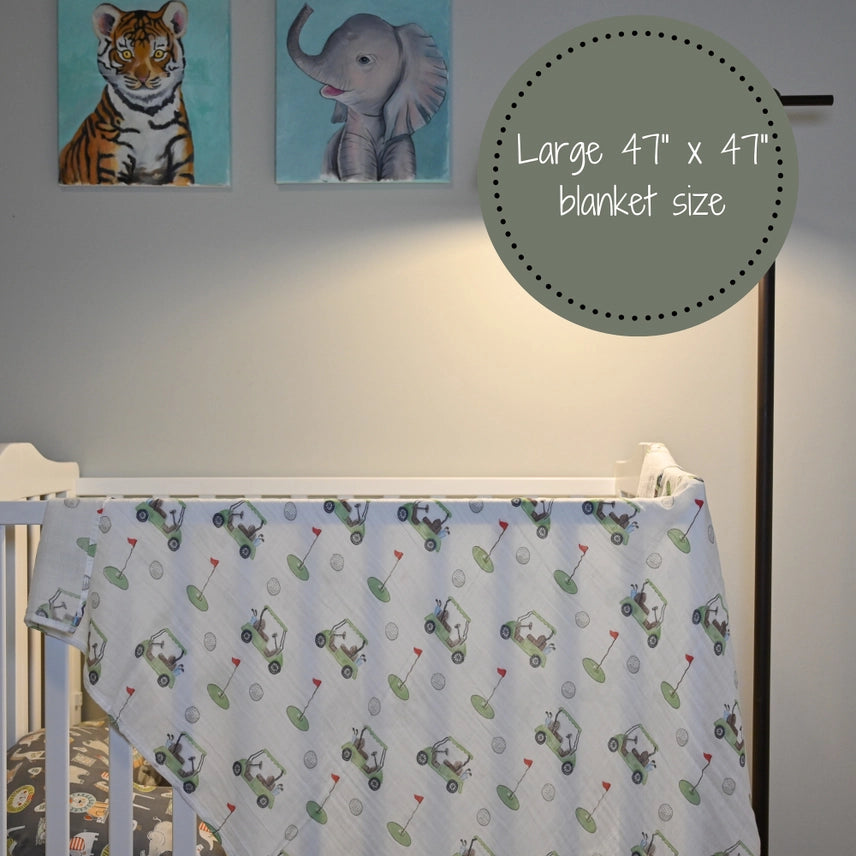 Muslin Baby Blanket with Golf Cart pattern draped over a crib in a nursery - AdoraBaby.co.uk