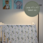 Muslin Baby Blanket with Golf Cart pattern draped over a crib in a nursery - AdoraBaby.co.uk