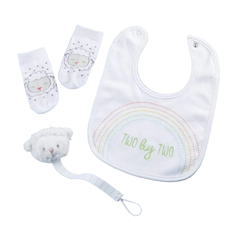 Baby bib, socks, and plush toy on a light gray background